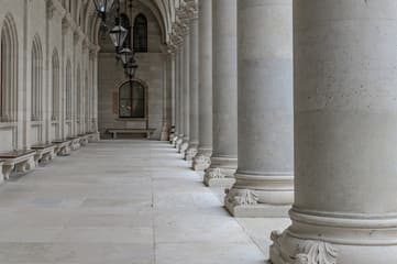 An ornate bank facade with subtly cracked stone texture under moody lighting.