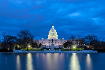The US Capitol at dusk under a sky split between warm and cool tones.