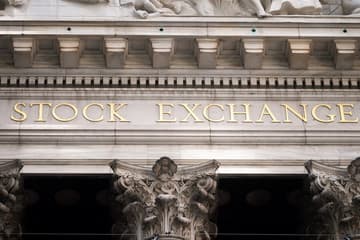 Split image of a sunny New York Stock Exchange facade and a rainy European exchange building.